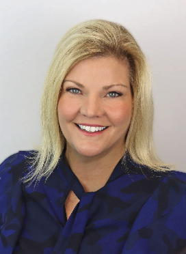 Smiling woman with blonde hair and blue blouse.